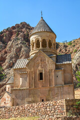 Church and beautiful natural landscape. Monastery in nature. Armenian Apostolic Church Noravank. Beautiful architecture of the church. Monastery against the backdrop of rocky mountains. Christianity i