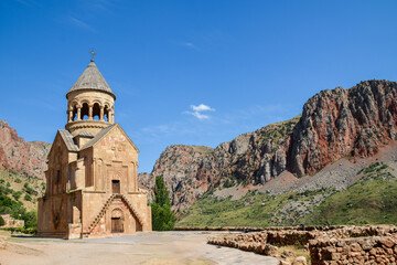 Church and beautiful natural landscape. Monastery in nature. Armenian Apostolic Church Noravank. Beautiful architecture of the church. Monastery against the backdrop of rocky mountains. Christianity i