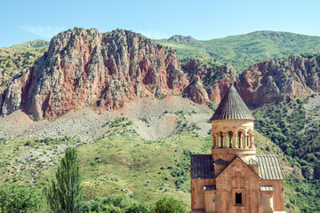Church and beautiful natural landscape. Monastery in nature. Armenian Apostolic Church Noravank. Beautiful architecture of the church. Monastery against the backdrop of rocky mountains. Christianity i