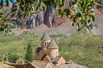 Church and beautiful natural landscape. Monastery in nature. Armenian Apostolic Church Noravank. Beautiful architecture of the church. Monastery against the backdrop of rocky mountains. Christianity i