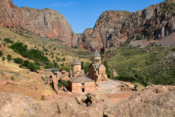 Church and beautiful natural landscape. Monastery in nature. Armenian Apostolic Church Noravank. Beautiful architecture of the church. Monastery against the backdrop of rocky mountains. Christianity i