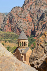 Church and beautiful natural landscape. Monastery in nature. Armenian Apostolic Church Noravank. Beautiful architecture of the church. Monastery against the backdrop of rocky mountains. Christianity i