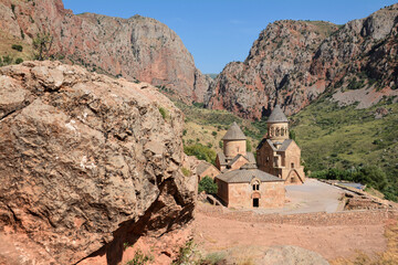 Church and beautiful natural landscape. Monastery in nature. Armenian Apostolic Church Noravank. Beautiful architecture of the church. Monastery against the backdrop of rocky mountains. Christianity i