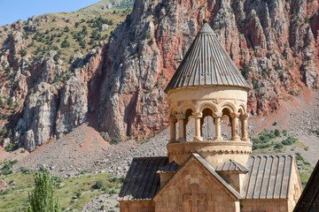 Church and beautiful natural landscape. Monastery in nature. Armenian Apostolic Church Noravank. Beautiful architecture of the church. Monastery against the backdrop of rocky mountains. Christianity i