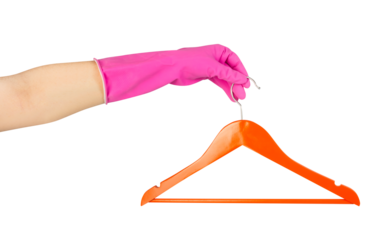 Isolated photo of female hand in gloves holding wooden hanger on white background.