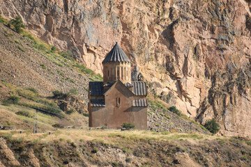 Church and beautiful natural landscape. Monastery in nature. Armenian monastery. Beautiful architecture of the church. Monastery against the backdrop of rocky mountains. Christianity