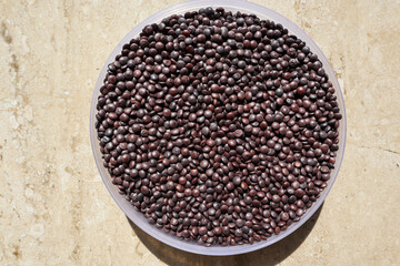 Masoor Dal in black brown color. Red lentil pulses in plate