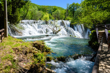 Fototapeta premium Amazing Martin Brod waterfalls on river Una in Bosnia and Herzegovina. Beautiful nature in Una national park with crystal clear water and amazing cascade waterfalls.