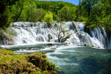 Fototapeta premium Amazing Martin Brod waterfalls on river Una in Bosnia and Herzegovina. Beautiful nature in Una national park with crystal clear water and amazing cascade waterfalls.