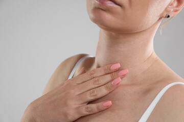 Woman with moles on her body against light background, closeup. Space for text