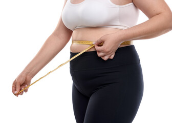 Weight loss. Plus size woman measuring waist with tape on white background, closeup