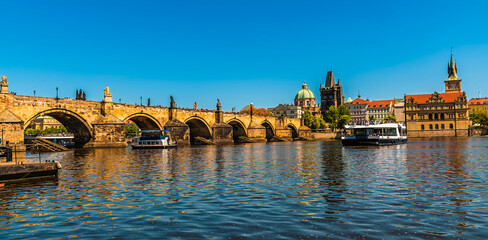 A view from the banks of the Vltava river towards the Charles Bridge in Prague in springtime
