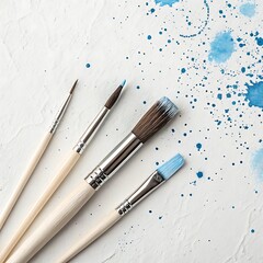 Obraz premium Art Paint brushes with colorful splatter on white canvas