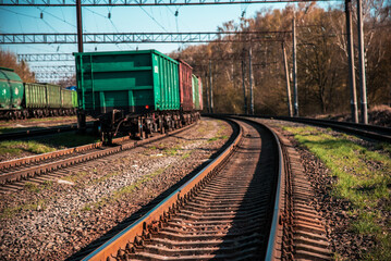 Fototapeta premium Abstract image with railway track and freight cars on background.