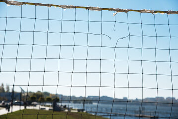 Torn volleyball net on the background of the city (failure, loss, breakdown - concept)