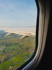 view from airplane window Aerial view from airplane window showing landscape below with clear sky, symbolizing travel and journey.