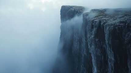 A Majestic Cliff Towering Against a Mystical and Misty Background Evokes Wonder and Awe