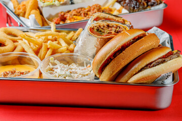 American food set - burger, french fries, shawarma, chicken wings, cheese sauce, onion rings and cole slaw