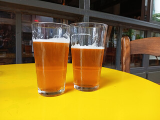 glass of blond beer on a table in a bar