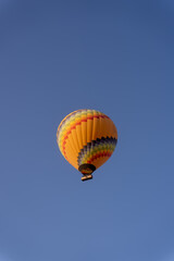 Hot Air balloons flying over rock formations at sunrise in Cappadocia, Goreme, Turkey