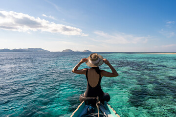 Young female tourist enjoying and looking at the underwater corals on vacation