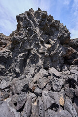 Textured volcanic rock by the sea