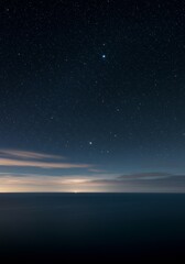 Fototapeta premium Starry Night Seascape - Tranquil ocean scene under a breathtaking starry night sky, showcasing the beauty of nature's celestial display
