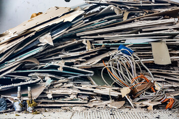 Destruction visible in a multi-story building collapse amidst rubble and debris during daylight...
