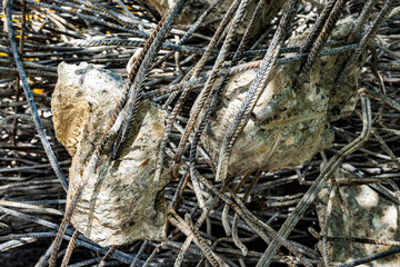 Destruction visible in a multi-story building collapse amidst rubble and debris during daylight hours in an urban environment