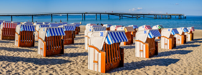 Beachside cabins lined on a sunny day showcasing vibrant colors and clear skies in a coastal...