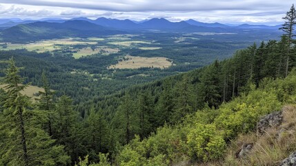 Fototapeta premium Serene Mountain Landscape Overlooking Lush Green Valley Surrounded by Majestic Hills and Dramatic Cloudy Sky in Scenic Nature Environment