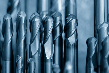 Close-up scene the group of used coating cutter ball nose end mill tools in the light blue scene.