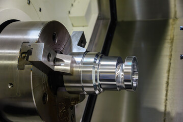 The CNC lathe machine forming cutting the cam shaft parts.