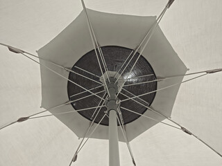 Monochrome view of the inside of a sun umbrella seen from below