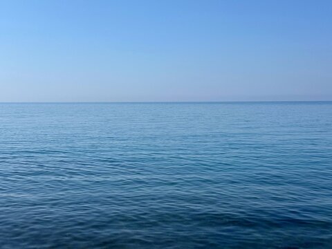 Blue calm sea and clear sky horizon.