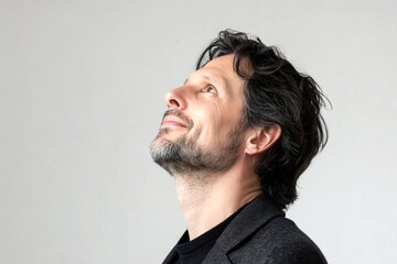 Obraz premium A glowing man radiating happiness and confidence. Pure white solid background. Classy men's wavy bob haircut - midlife white man with black hair. Artwork of style for aging men.