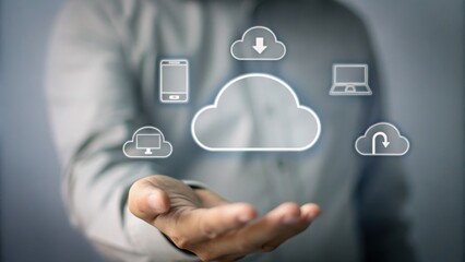 A person holds out their hand with digital cloud computing icons floating above, representing data storage and connectivity.