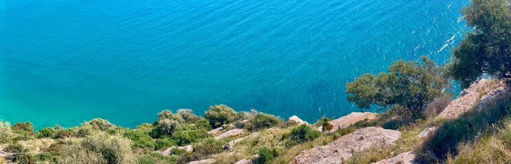 view from high cliffs on a beautiful turquoise blue sea in Puglia in italy