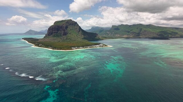 Stunning aerial panorama of the iconic Le Morne Brabant mountain and peninsula in Mauritius, with turquoise lagoon, coral reefs and underwater waterfall