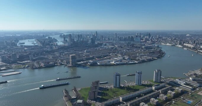 city view on Rotterdam skyline from a distance, SOuth Holland, The Netherlands, Nieuwe Maas river, solar panel on water. Aerial video