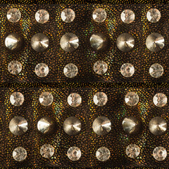 Seamless 4k photo texture material of dark golden glittered synthetic material with decorative...