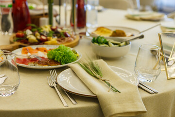 served table, glasses, plates, vase with forge