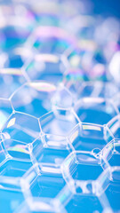 Transparent Hexagonal Bubbles Reflect Light in a Colorful Pattern on a Blue Surface