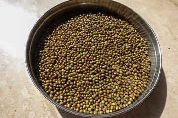 Whole Green Gram lentils, moong dal Indian uncooked pulses in plate