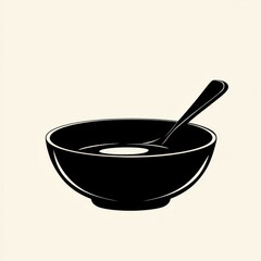 Simple black bowl with spoon on neutral background for culinary or dining themes