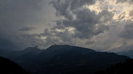 Obraz premium ark stormy clouds over silhouette of mountains in Vanoise national park, France 