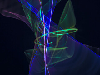 colorful light trails in dark background. Abstract light routes that rotate in vibrant colors....