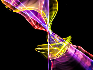 colorful light trails in dark background. Abstract light routes that rotate in vibrant colors....