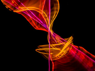 colorful light trails in dark background. Abstract light routes that rotate in vibrant colors....