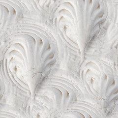 Seamless 4k photo texture of white ornate or patterned marshmallow.